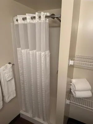 a shower curtain in a bathroom with white towels at SAIT Residence & Conference Centre - Calgary in Calgary