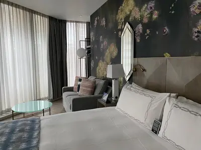 a bedroom with a bed and a living room at EXchange Hotel Vancouver in Vancouver
