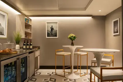 a wine tasting room with two tables and chairs at EXchange Hotel Vancouver in Vancouver