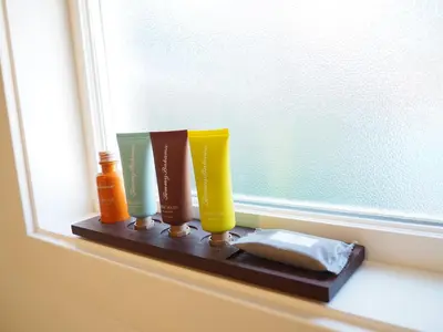 a window sill with four different colored vases on it at Riverside Resort & RV Park in Qualicum Beach