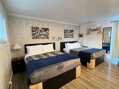 a hotel room with two beds in a room at Riverside Resort & RV Park in Qualicum Beach