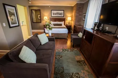 a hotel room with a couch and a bed at Hume Hotel & Spa in Nelson