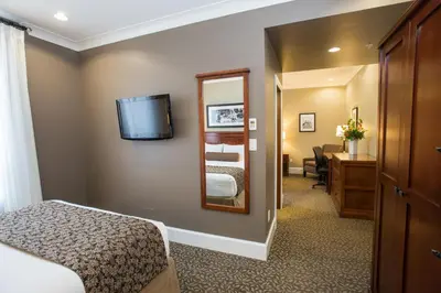 a hotel room with a bed and a mirror at Hume Hotel & Spa in Nelson