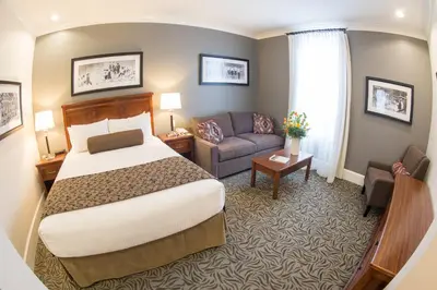 a hotel room with a bed and a couch at Hume Hotel & Spa in Nelson