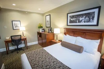 a hotel room with a bed and a desk at Hume Hotel & Spa in Nelson