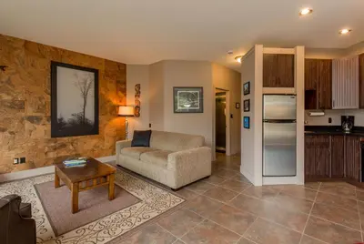 a living room with a couch and a table at Inn the Estuary in Nanoose Bay
