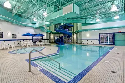 a swimming pool with a slide in a building at Canalta Camrose in Camrose
