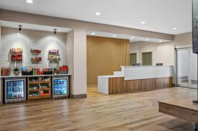 an empty lobby of a store with a cash register at Ramada by Wyndham Drumheller Hotel & Suites in Drumheller