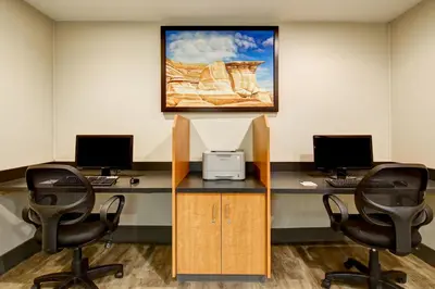 an office with two desks with two computer monitors at Canalta Jurassic - Drumheller in Drumheller