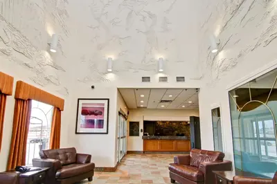 a lobby with couches and chairs in a building at Canalta Jurassic - Drumheller in Drumheller