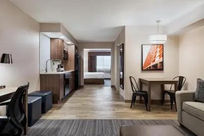 a living room with a couch and a table at Canalta Airdrie in Airdrie
