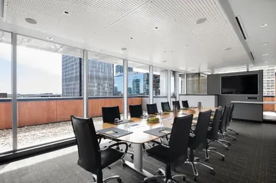 an office with a conference room with a table and chairs at Hotel Le Germain Calgary in Calgary