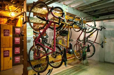 two bikes hanging on a wall in a garage at Ocean Island Inn | Backpackers | Suites in Victoria