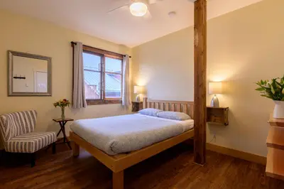 a bedroom with a four poster bed and a chair at Riding Fool Accommodation in Cumberland