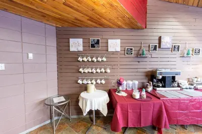 a room with two tables and a coffee shop at Vegreville Garden Inn in Vegreville