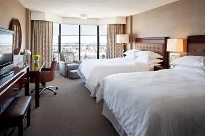 a hotel room with two beds and a flat screen tv at Red Deer Resort & Casino in Red Deer