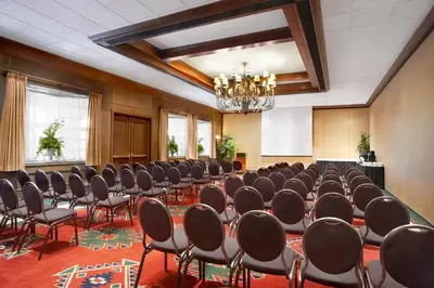 a room with rows of chairs and a chandelier at Red Deer Resort & Casino in Red Deer
