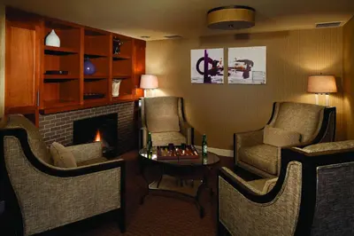 a living room with chairs and a fireplace at Red Deer Resort & Casino in Red Deer