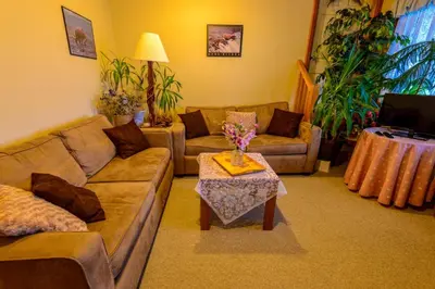 a living room with a couch and a table at PineWood Guesthouse in Peachland