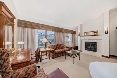 a living room with a couch and a fireplace at Jasper Inn & Suites by INNhotels in Jasper