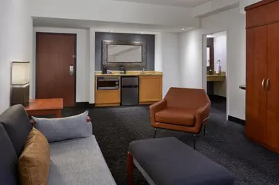 a living room with a couch and a chair at Courtyard by Marriott Calgary Airport in Calgary