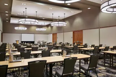 a large room with tables and chairs in it at Courtyard by Marriott Calgary Airport in Calgary