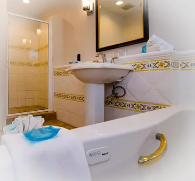 a bathroom with a sink and a bath tub at Galiano Oceanfront Inn & Spa in Galiano