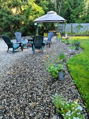 a patio with chairs and a gazebo and flowers at Grizzly Paw B&B in Clearwater