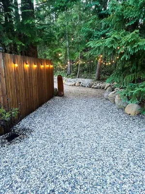a garden with a fence with lights on it at Grizzly Paw B&B in Clearwater