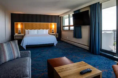 a hotel room with a bed and a couch at Blue Horizon Hotel in Vancouver