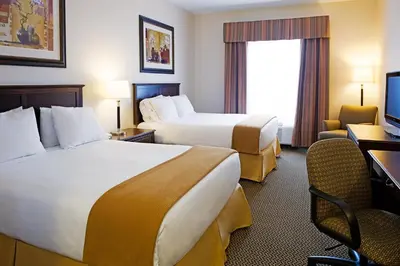 a hotel room with two beds and a desk at Holiday Inn Express Hotel & Suites - Slave Lake by IHG in Slave Lake