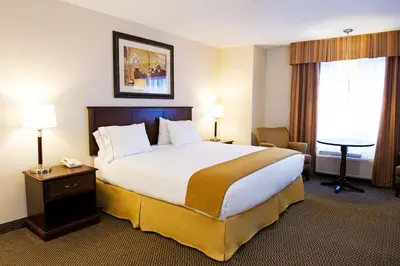 a hotel room with a large bed and a window at Holiday Inn Express Hotel & Suites - Slave Lake by IHG in Slave Lake