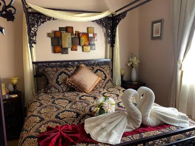 two swans wrapped in towels sitting on a bed at Eagle Rock Bed and Breakfast in Chemainus