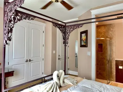 a bedroom with a bed and a shower at Eagle Rock Bed and Breakfast in Chemainus