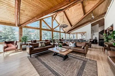 an open living room with couches and a table at Canmore Rocky Mountain Inn in Canmore
