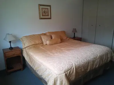 a bedroom with a bed with two lamps on it at Rosedale Manor in Duncan