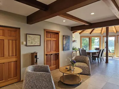 a living room with a table and chairs and a dining room at Snug Harbour Inn in Ucluelet