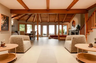 a living room with chairs and a table at Snug Harbour Inn in Ucluelet