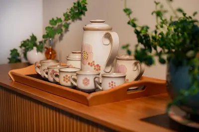 a tray of tea cups and a pitcher on a table at Snug Harbour Inn in Ucluelet
