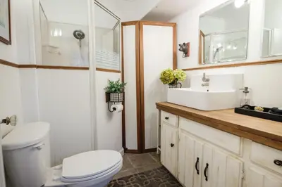 a bathroom with a toilet and a sink at Bramblebank Cottages in Harrison Hot Springs