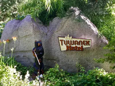 a statue of a squirrel on a rock with a sign at The Tuwanek Bed and Breakfast in Sechelt