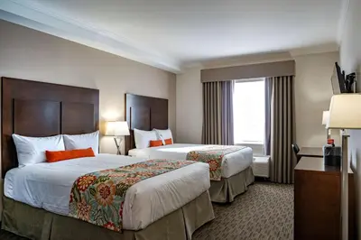 a hotel room with two beds and a window at Coast Oliver Hotel in Oliver