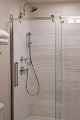 a bathroom with a shower with a glass door at Coast Oliver Hotel in Oliver