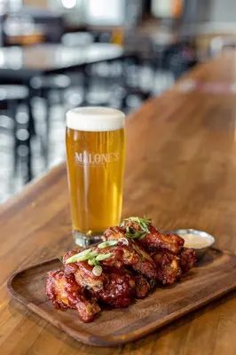 a plate of food with a glass of beer at The Cambie Hostel Seymour in Vancouver
