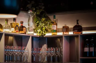 a shelf full of wine glasses and bottles at The Cambie Hostel Seymour in Vancouver