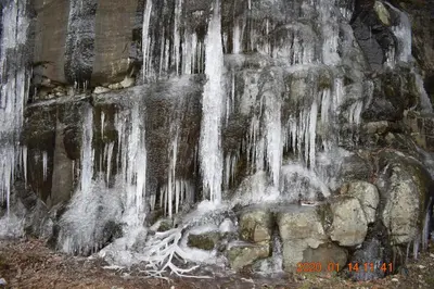 a painting of a waterfall with icicles at High Point Resort in Quathiaski Cove