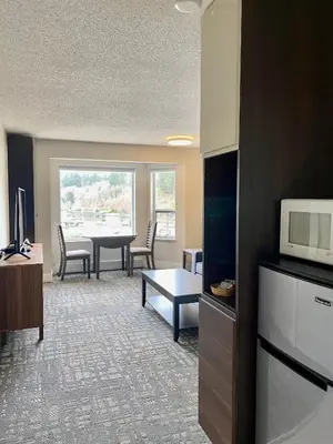 a living room with a table and a microwave at High Point Resort in Quathiaski Cove