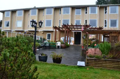 a building with a courtyard with a table and chairs at High Point Resort in Quathiaski Cove