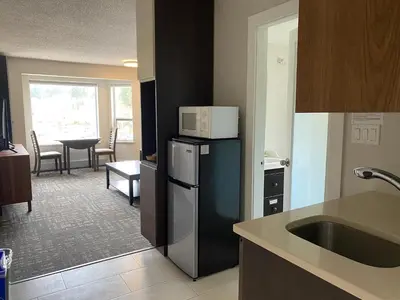 a kitchen with a microwave on top of a refrigerator at High Point Resort in Quathiaski Cove
