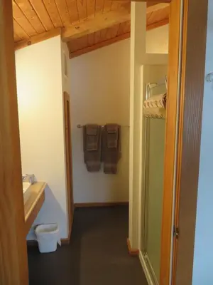 a bathroom with a toilet and a sink and towels at Alpenglow Bed and Breakfast in Kimberley